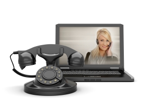Woman on laptop screen and old rotary phone